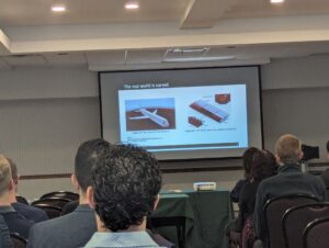 Khodr presenting his research on curved flow dynamics